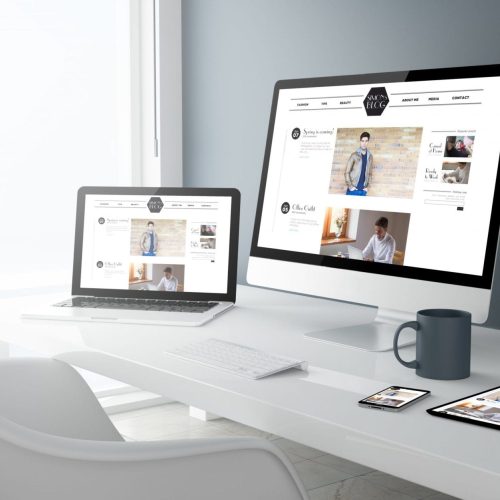 laptop, computer and tablet with a mug on table